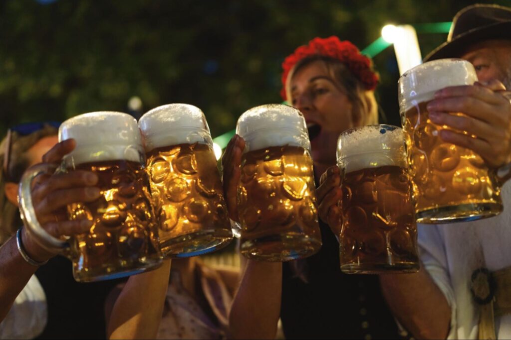 people holding glass of beer