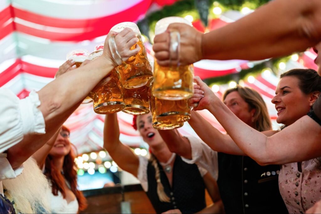 people doing cheers with their beer glass